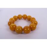 A faux amber beaded bracelet, 3½" diameter