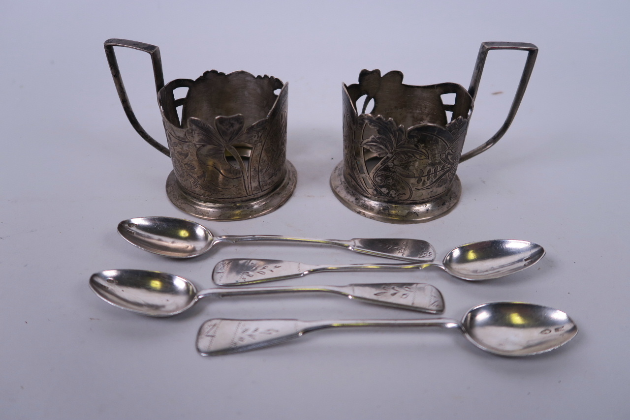 A pair of Russian silver plated tea glass holders with engraved floral decoration, and a set of four