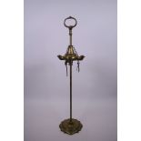 A Victorian brass whale oil lamp with adjustable four branch reservoir, 23" high