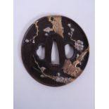 A Japanese bronze tsuba with raised cherry tree decoration, 3", with character inscription