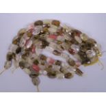 Eight strings of polished crystal lozenge shaped beads, 15" long