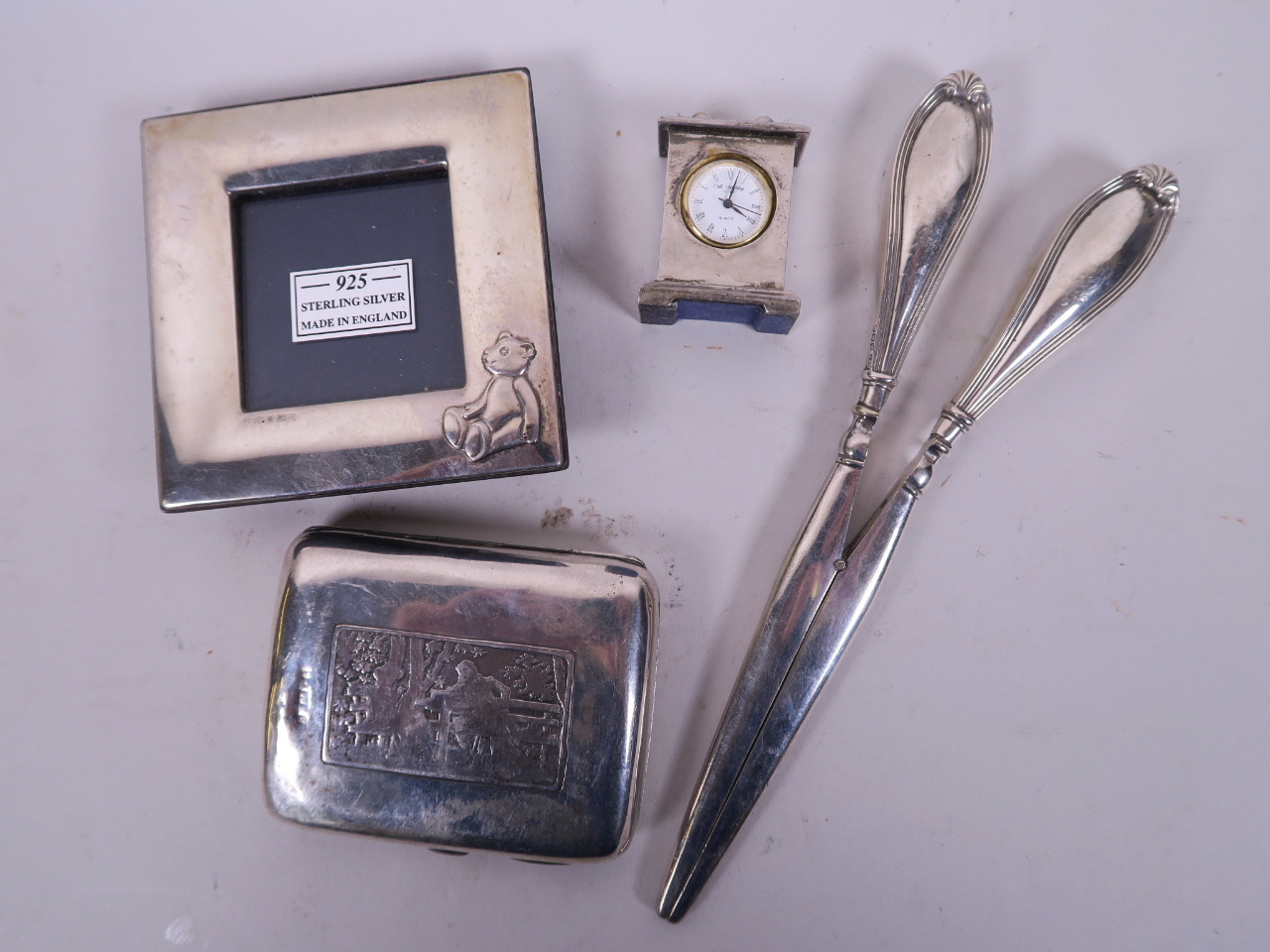 A pair of C19th silver handled glove stretchers, a small sterling silver photo frame, a hallmarked