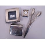 A pair of C19th silver handled glove stretchers, a small sterling silver photo frame, a hallmarked