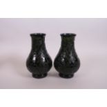 A pair of Chinese spinach jade vases with carved decoration of dragons chasing the flaming pearl, 6"