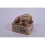 A Chinese soapstone seal with carved kylin decoration to top, 1½" x 2"