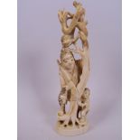 A Japanese carved marine ivory figurine of a hunter and child standing by a tree with a monkey and