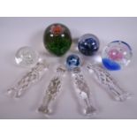 Four antique cut glass knife rests, 5½" long, together with five decorative glass paperweights (9)