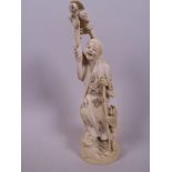 A Japanese carved ivory figurine of a traveller with two bird headed creatures, 9" high, signed