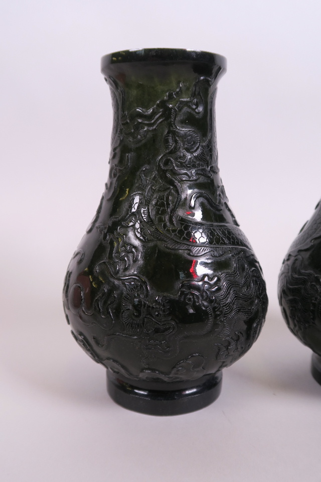 A pair of Chinese spinach jade vases with carved decoration of dragons chasing the flaming pearl, 6" - Image 2 of 3