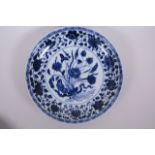 A Chinese blue and white porcelain charger with floral decoration, 6 character mark to base, 11"