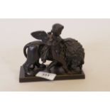 A late C19th bronze patinated iron figure of a putti with lion, marked E.G. Zimmerman of Hanau,