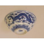 A Chinese dragon bowl with blue and white decoration, maker's mark to back, chip to rim, 6½"