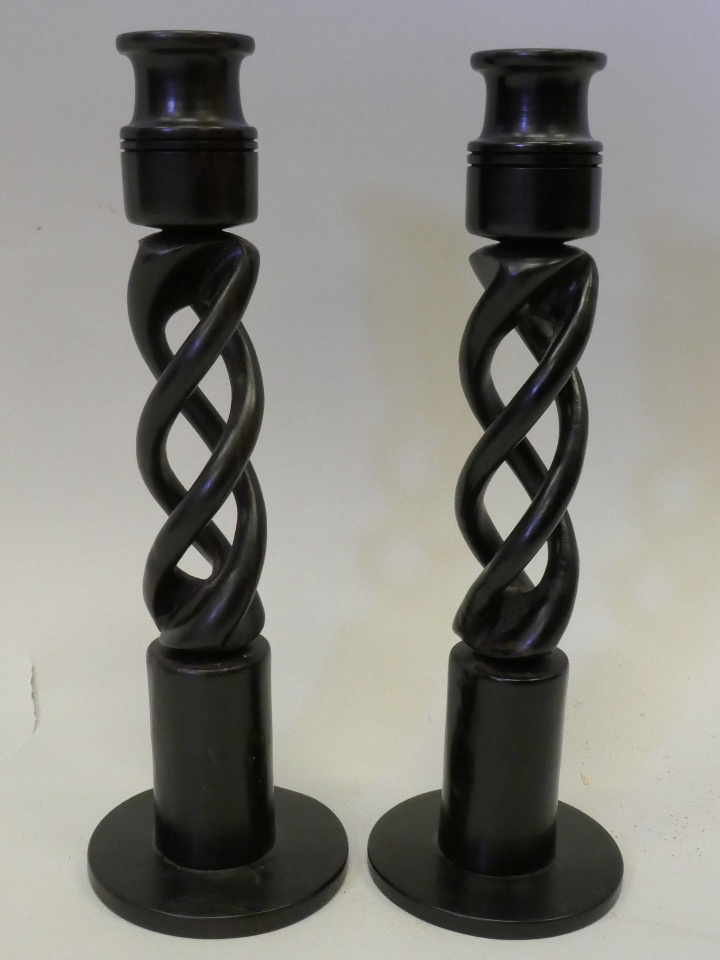 A pair of ebony turned open barleytwist candlesticks, 9" high