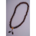 A string of beads consisting of nuts and nut kernels, 30" long