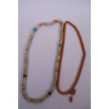 A string of amber style mala beads, together with a string of bone beads, longest 37"