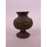 An Indo-Persian bronze spill vase, with chased decoration of riders on horseback and other