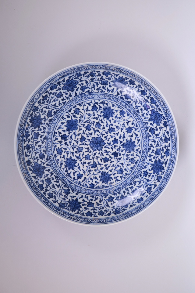 A Chinese blue and white porcelain charger with scrolling floral decoration, 12" diameter, seal mark