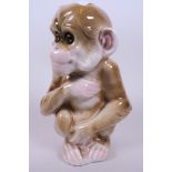 An early Naples porcelain novelty electric lamp in the form of a seated monkey, 7" high