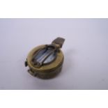 A reproduction brass cased military field compass, engraved 'T.G. and Co. Ltd., London', 2½"