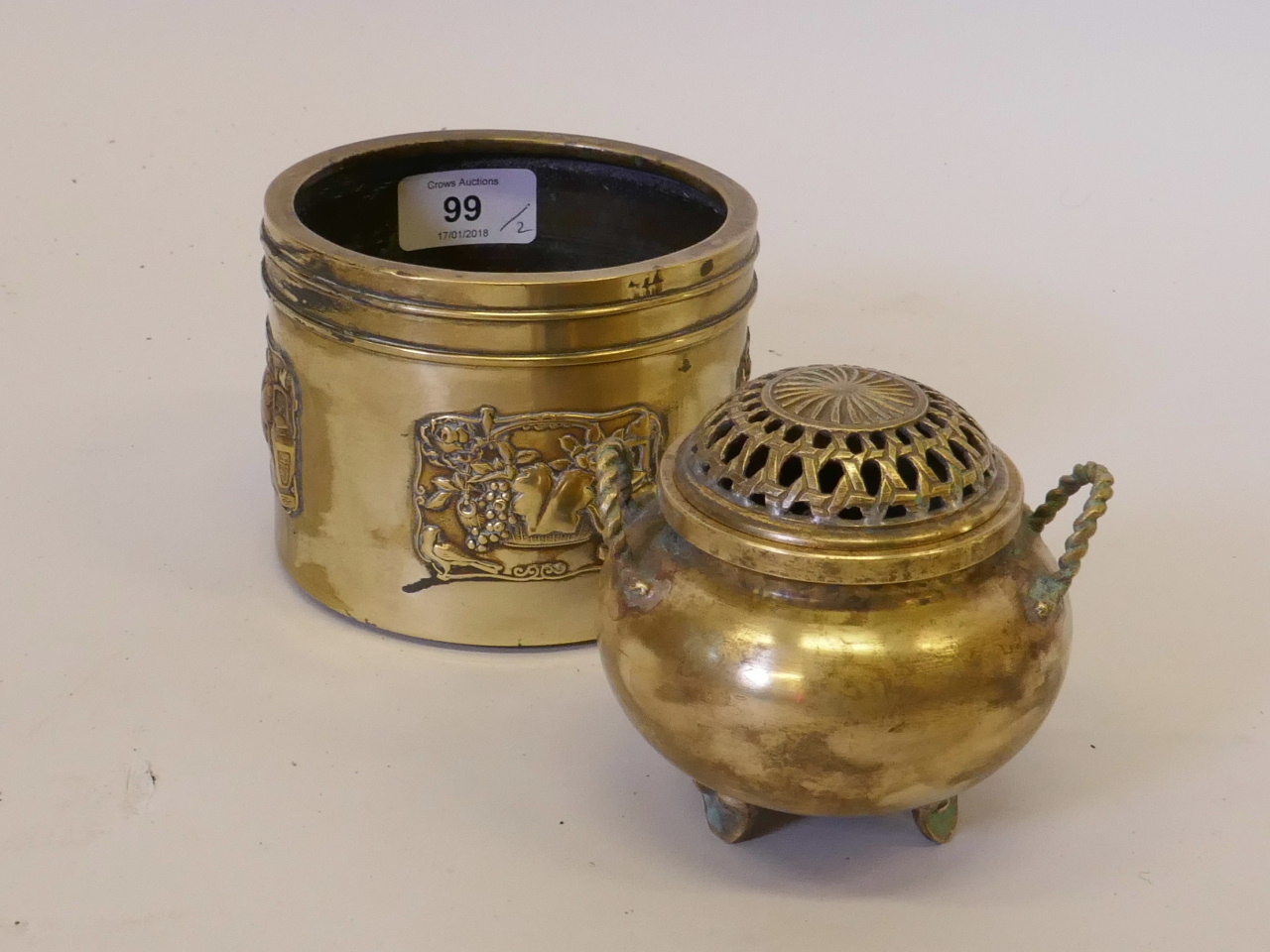 A Chinese bronze censer with pierced cover and twist handles, raised on tripod scroll supports,