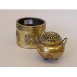 A Chinese bronze censer with pierced cover and twist handles, raised on tripod scroll supports,