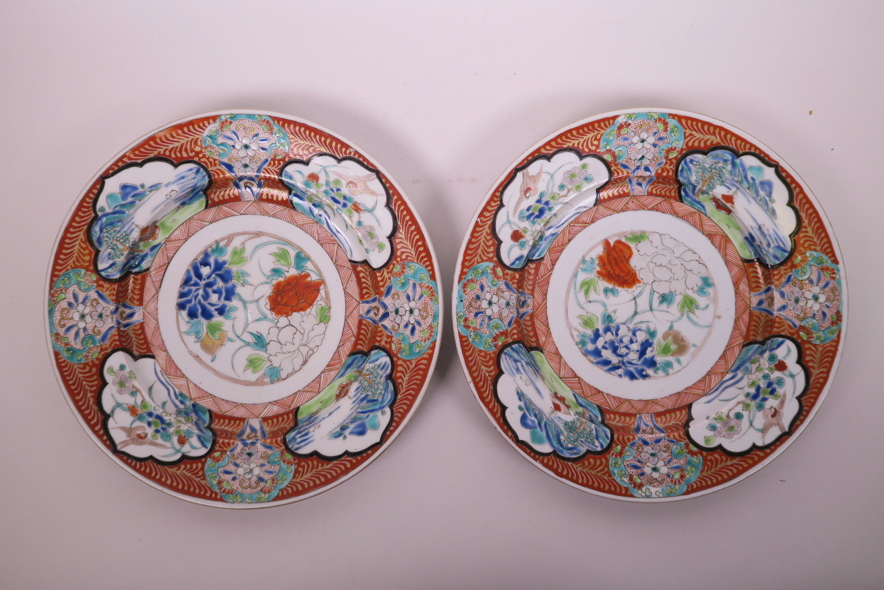 A pair of Chinese polychrome enamelled porcelain cabinet plates, decorated with landscape scenes,