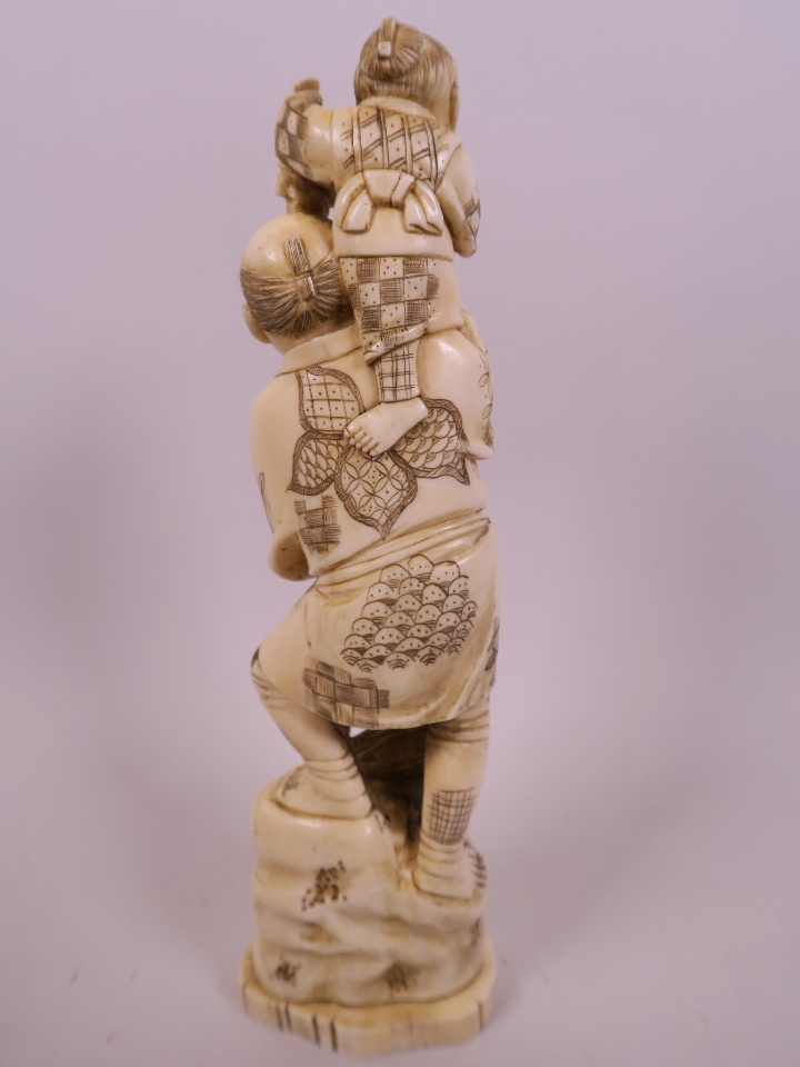 A Japanese carved marine ivory figurine of a farmer with a small child on his shoulder, a basket - Image 4 of 4