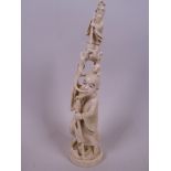 A Japanese carved ivory figurine of a sage with a tree root on his head and another small sage
