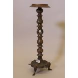 A Middle Eastern three section brass lamp stand, with engraved decoration, raised on tripod