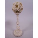 A Canton carved ivory puzzle ball on stand, 1¾" diameter