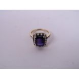 A 9ct yellow gold amethyst set ring encircled by seed pearls, approximate size 'Q'