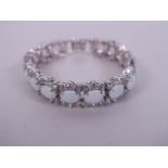 A silver, cubic zirconia and opalite set panelled bracelet, 7" long