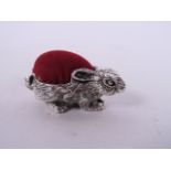 A silver pin cushion in the form of a rabbit, 1½" long