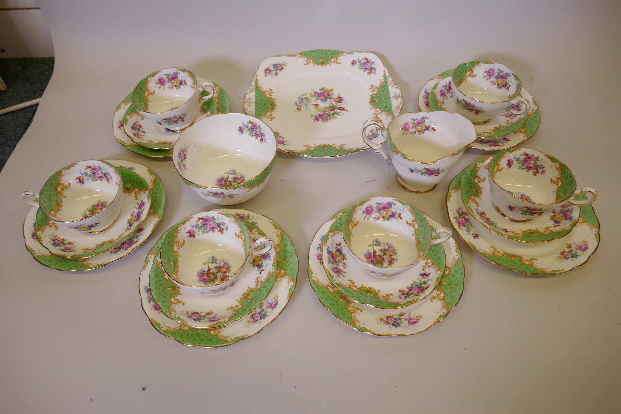 A Paragon China six place setting porcelain tea service decorated in a traditional flowers and