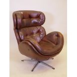 A 1970s leatherette tilt and swivel easy chair