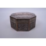 An Oriental silvered metal octagonal box with repoussé decoration to lid of Angkor Wat, mark to