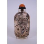 A Chinese reverse painted snuff bottle depicting a bathhouse scene, character inscription verso,