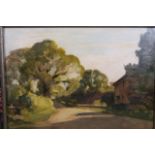 A framed oil of a village street, inscribed verso P.W. Steer