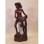 An Indonesian/Balinese carved hardwood figure of a fisherman, signed to base, 40" high