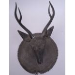 An Eastern bronze wall plaque in the form of a deer's head, 8" diameter