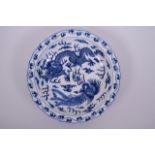 A Chinese blue and white porcelain dish with lobed rim, decorated with a dragon and phoenix
