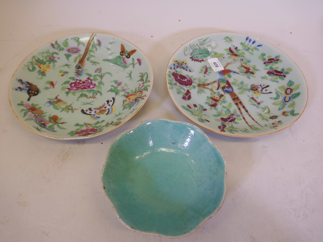 A pair of Chinese celadon ground plates with enamel decoration of Asiatic pheasants, 10" diameter,