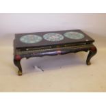 A Chinese lacquered occasional table, with painted and gilt decoration, the top inset with three