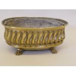 A C19th brass planter, with gadrooned and beaded decoration, raised on paw feet, 18" wide x 8" high