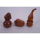 A collection of three carved wood netsuke in the form of gourds, carp and toads, signed to base,