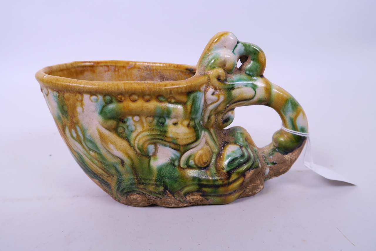 A Chinese Sancai glazed terracotta cup in the form of a dragon's head, 7½" long