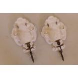 A pair of carved and gessoed wood plaques with bronze candle sconces, 17" long