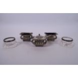 A set of three hallmarked silver salts with gadrooned decoration and blue glass liners (Chester 1895