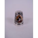 A silver thimble set with cold enamel plaque depicting a cat, 1"