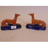 A pair of C19th Staffordshire greyhound quill holders, 6" long